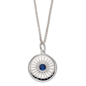 Sterling silver disc pendant with a blue crystal and engraved line details