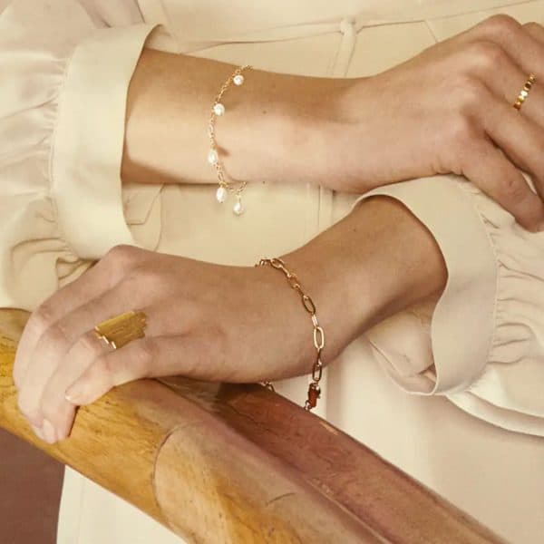 Lady wearing gold esther bracelet by Pernille Corydon