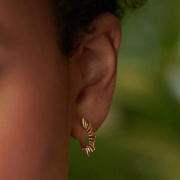 Model wearing gold plated mini sunray hoop earrings at silverado